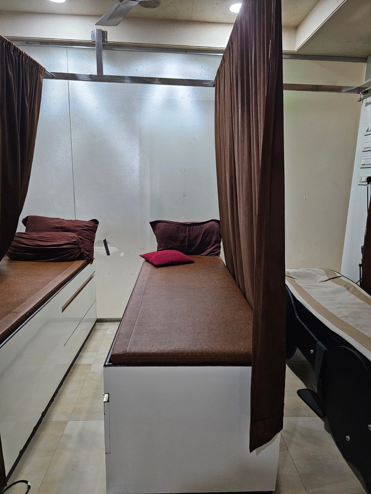 Therapy room with treatment bed and privacy curtains