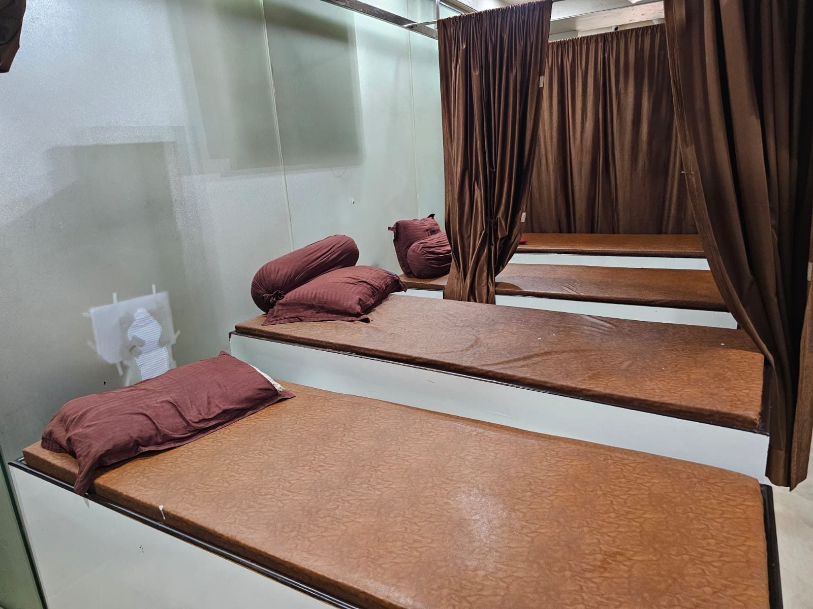 Treatment beds with privacy curtains at Mahadev Health Care Center